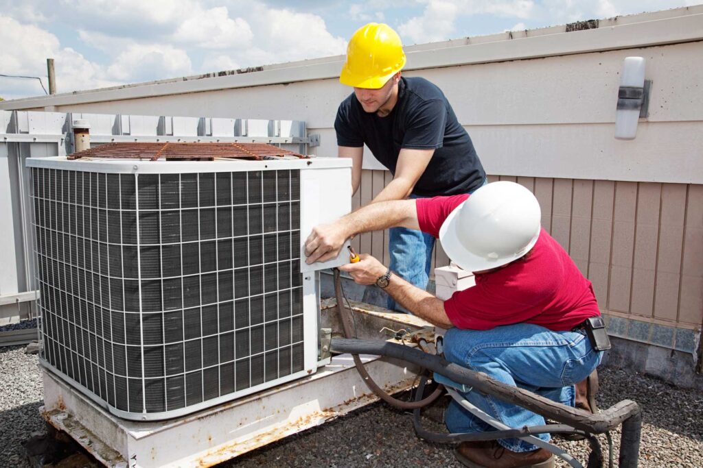 HVAC technicians working on a rooftop unit